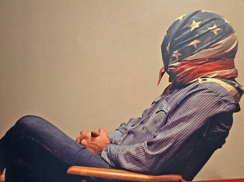 John M. White with American flag over his head